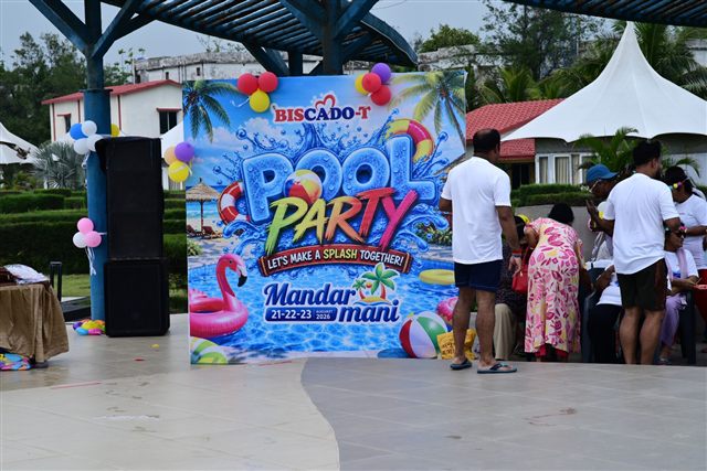Pool party stage backdrop with the team gathered around