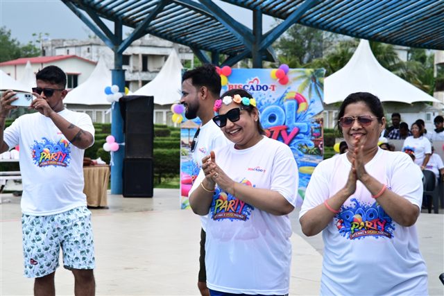 Team members in party shirts cheering together