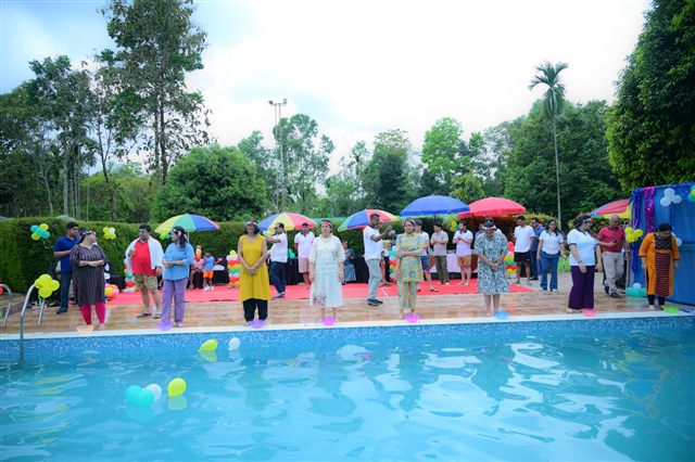 Guests around the pool with colourful umbrellas