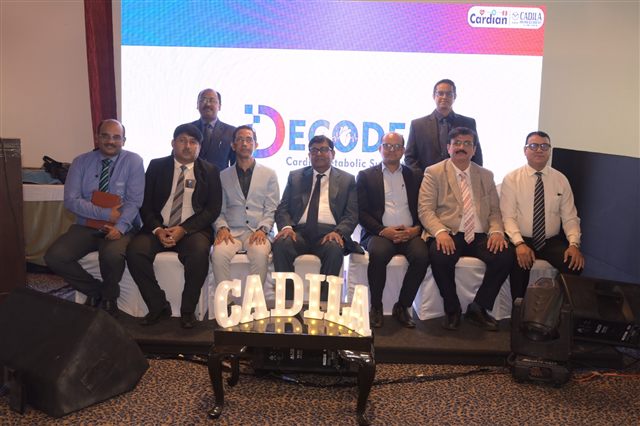 Panel of delegates seated in front of the summit backdrop